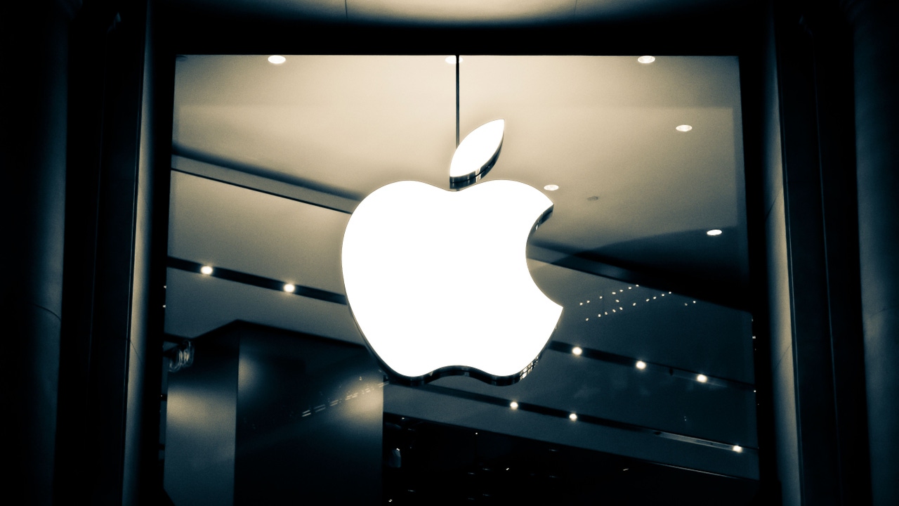 Glowing Apple logo on a window Glowing Apple logo on a window