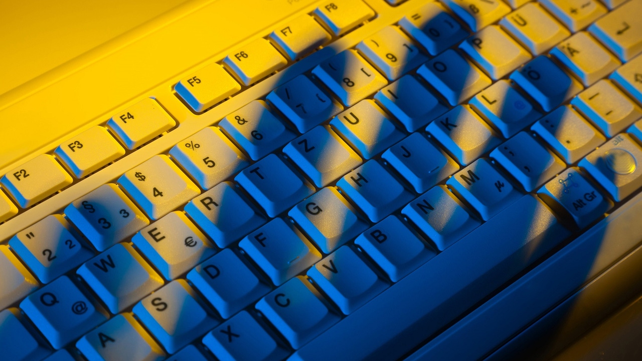 shadow of three fingers on keyboard