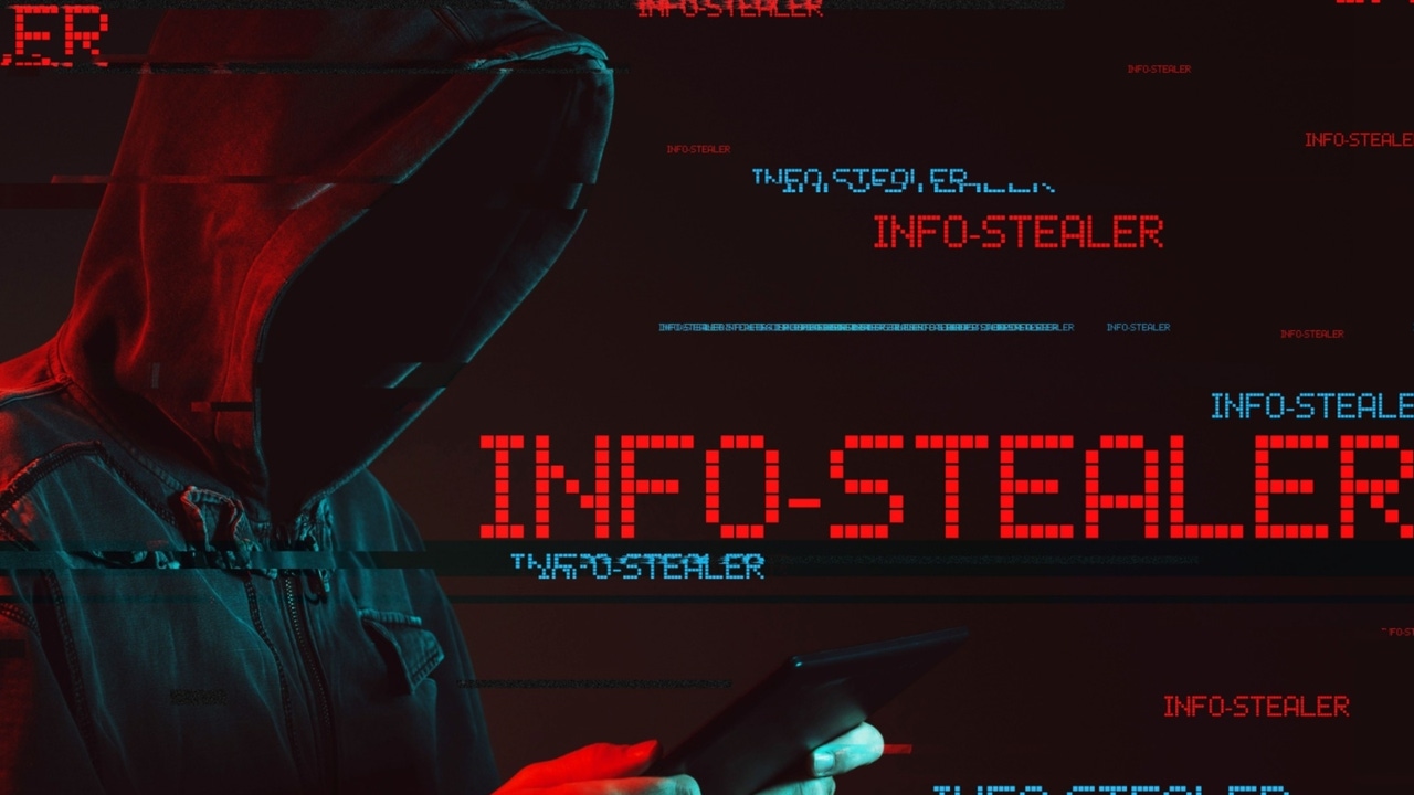 A person in a hooded sweatshirt holding a tablet device with the word "infostealer" appearing around them in red and blue A person in a hooded sweatshirt holding a tablet device with the word "infostealer" appearing around them in red and blue