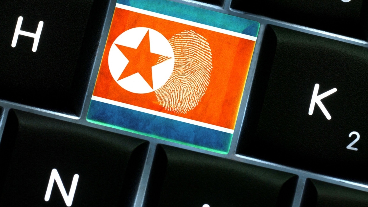 The North Korean flag on the key of a computer keyboard with a fingerprint on it in between the H and K keys The North Korean flag on the key of a computer keyboard with a fingerprint on it in between the H and K keys