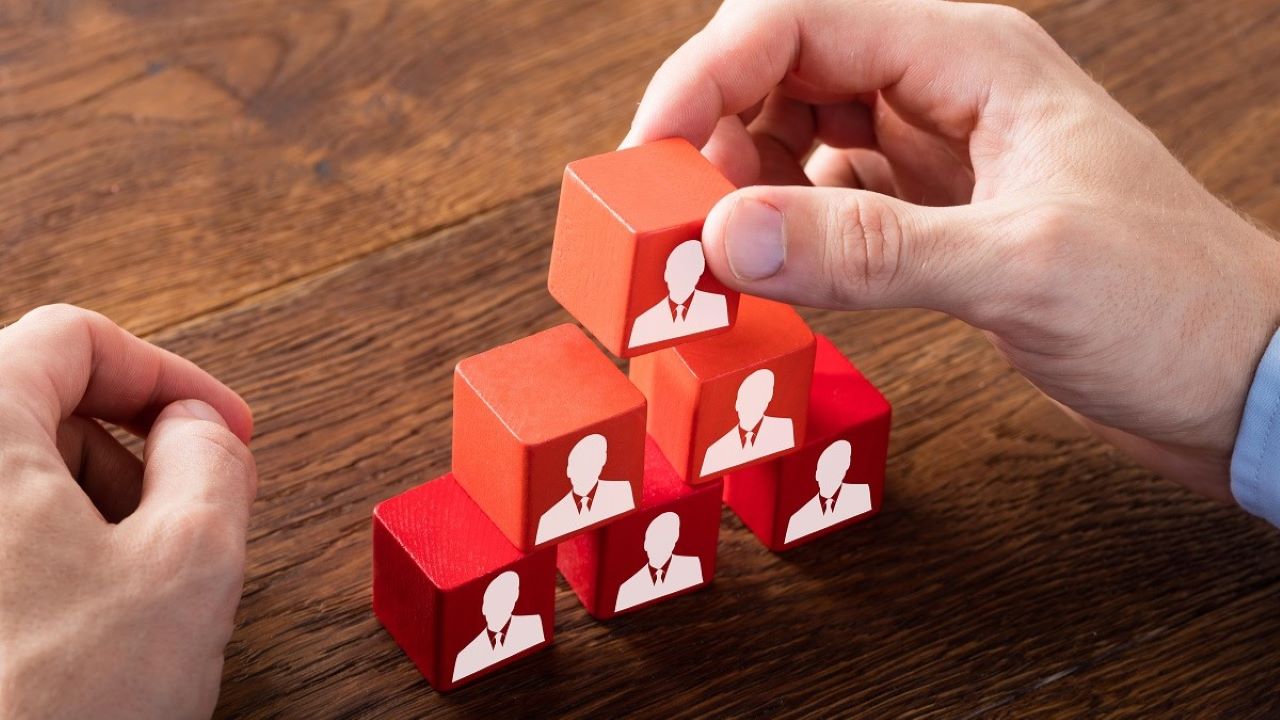A pile of red block with silhouettes on one side.