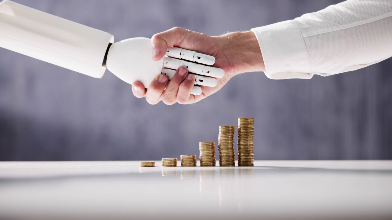 Robot and human shaking hands with coins stacked in the background 