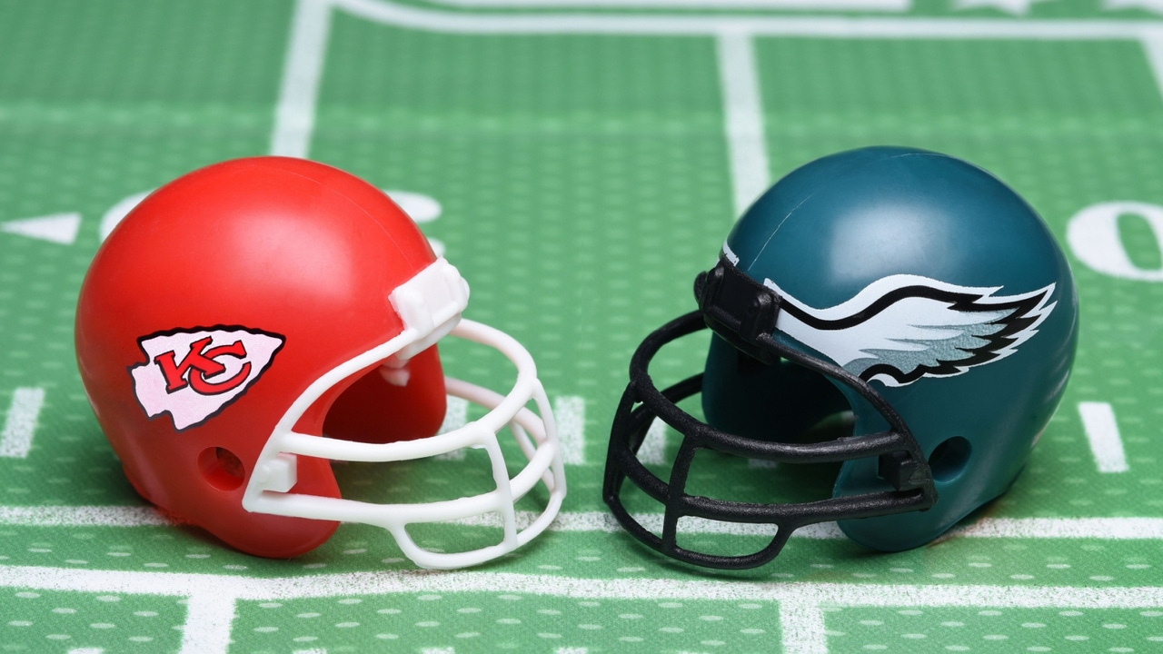 Toy football helmets of the Kansas City Chiefs and Philadelphia Eagles, on a gridiron Toy football helmets of the Kansas City Chiefs and Philadelphia Eagles, on a gridiron