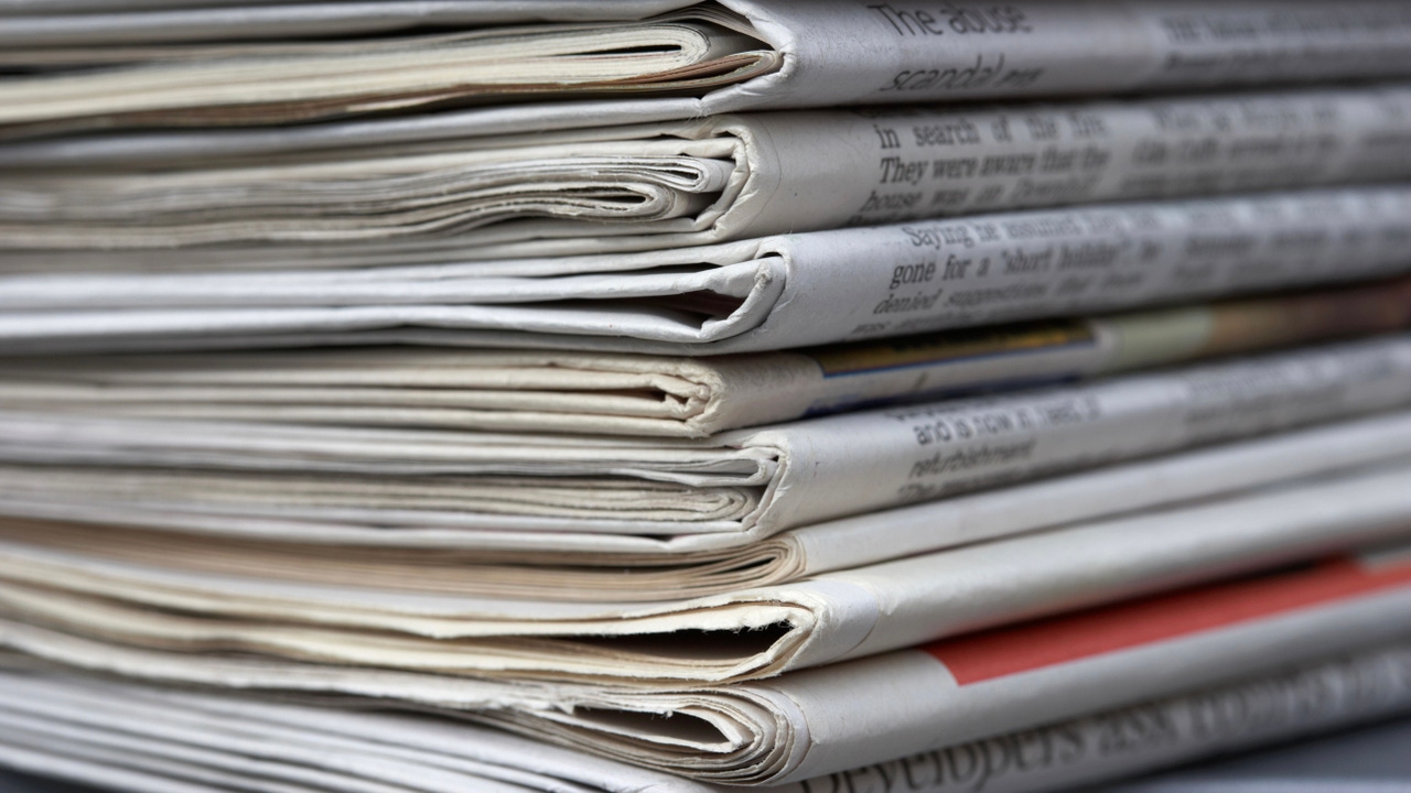 A stack of folded newspapers A stack of folded newspapers