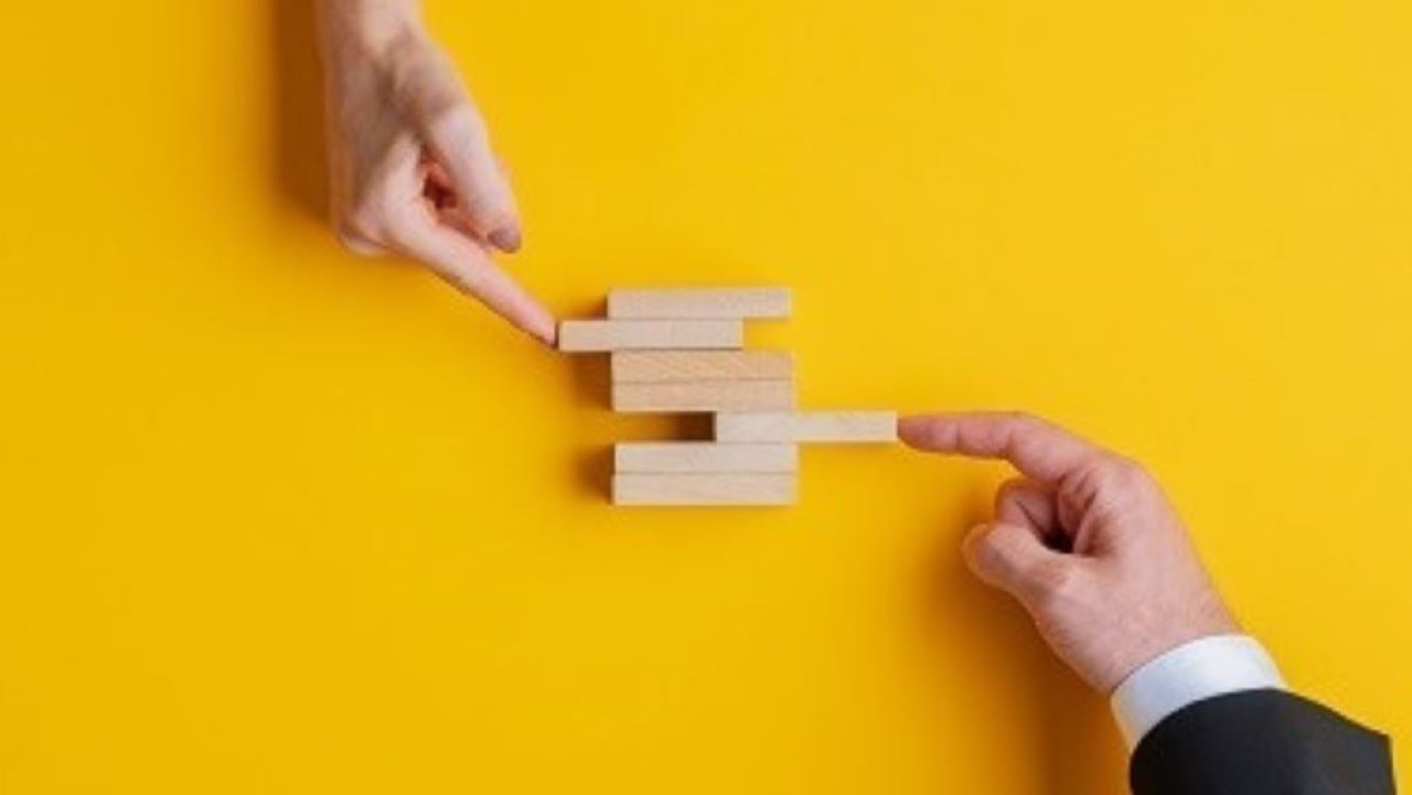 Two hands pushing blocks together to make a new box Two hands pushing blocks together to make a new box